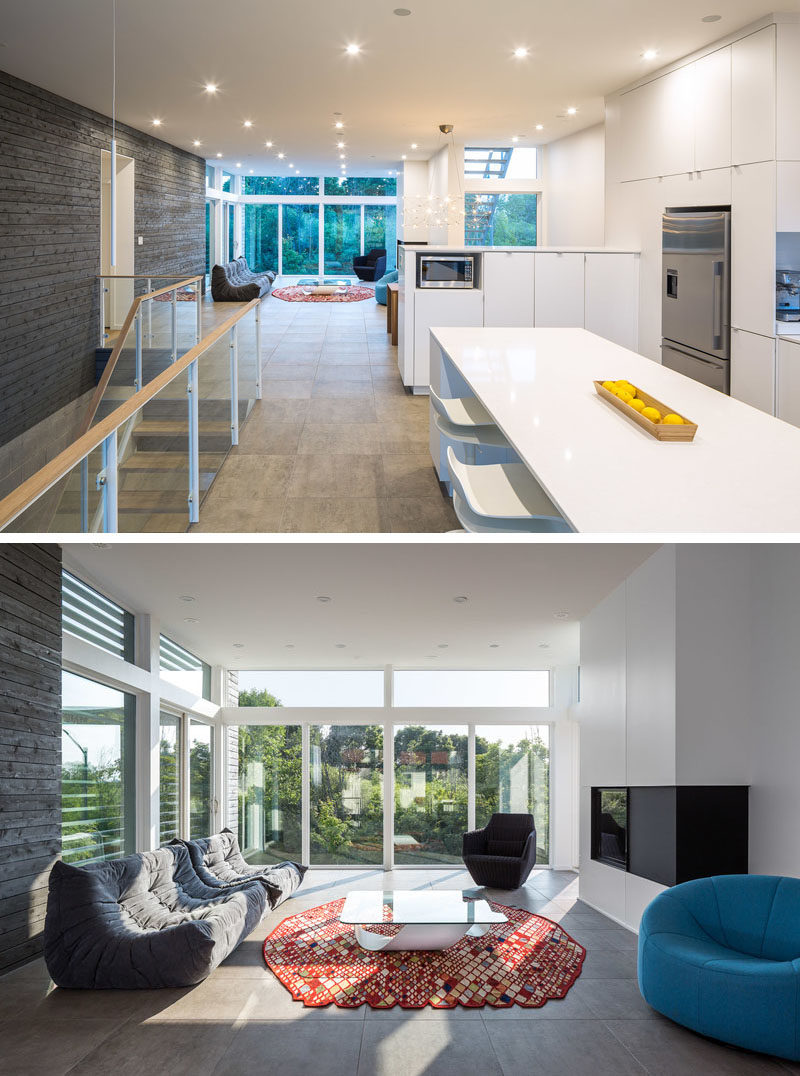 Living Room Ideas - In this modern open-plan living room, horizontal louvers and sliding doors that allow cross-ventilation for passive cooling. The sliding doors by the fireplace also provide access to exterior stairs that lead up to a roof terrace. #LivingRoomIdeas #Windows #Louvers