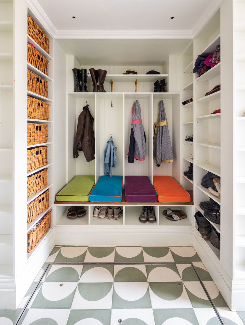 Mudroom Ideas - This modern mudroom features four designated areas with cushioned seating, and plenty of open shelving and basket storage. #MudroomIdeas #Mudroom #BootRoom #InteriorDesign #ShoeStorage