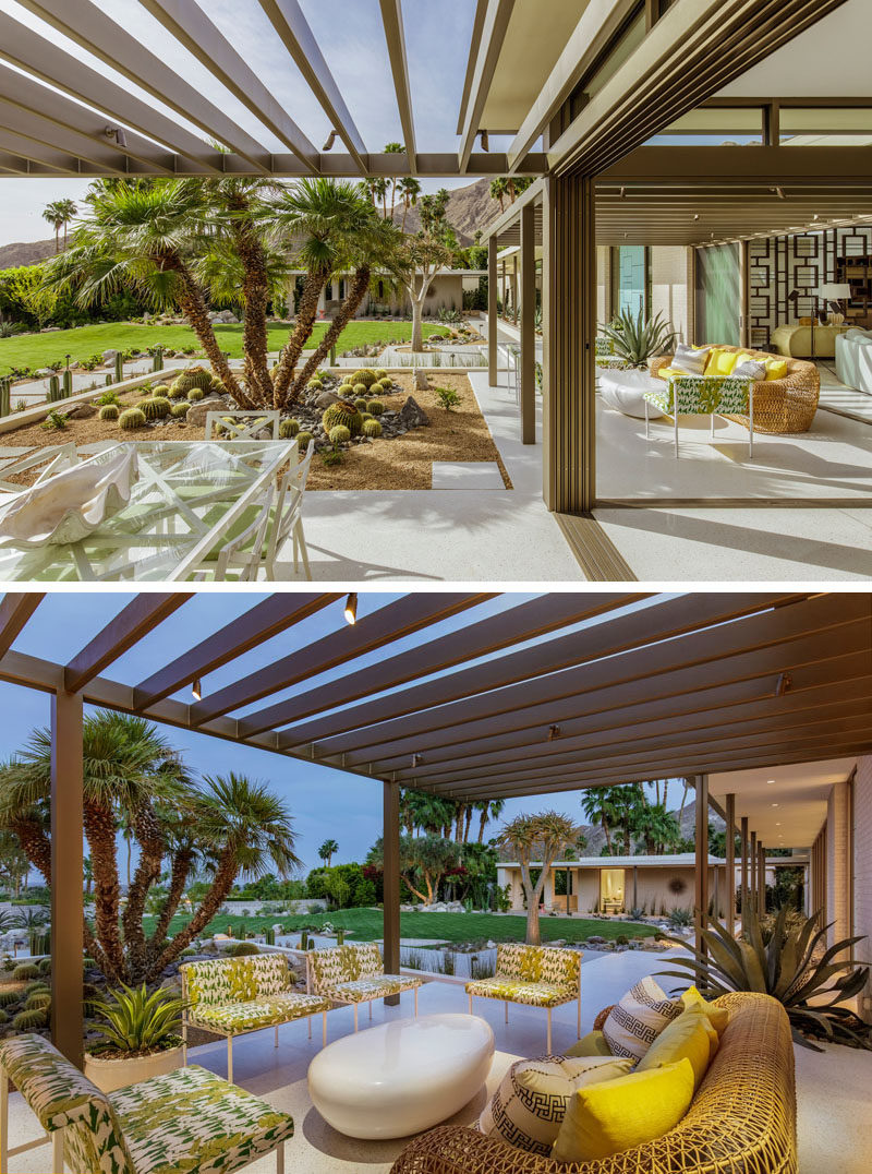 This renovated house has walls of glass that open to reveal outdoor seating areas with pergolas. #OutdoorSpace #Pergola #LandscapeDesign #Landscaping