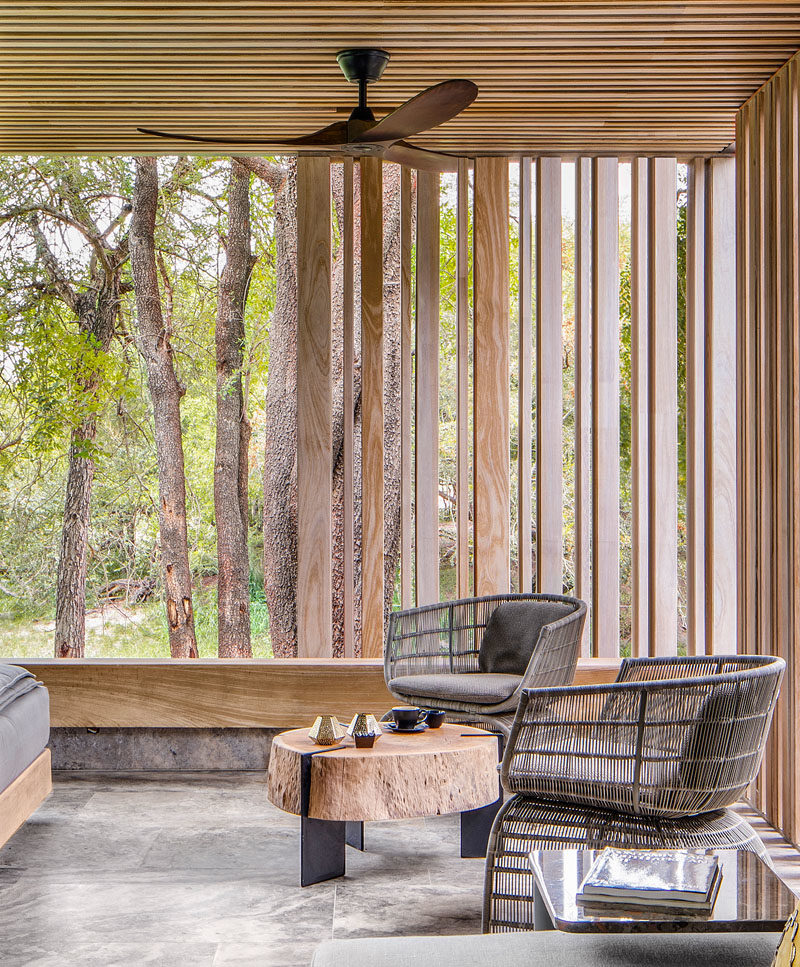 This outdoor sitting area is surrounded by wood slats that provide shade, and complement the trees outside. #SittingArea #WoodSlats