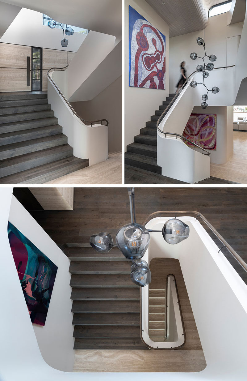 Stair Ideas - This modern staircase features a Lindsey Adelman branching bubble chandelier, while the paintings are ‘Antara’ by Betty Kunita Pumani and ‘Sweets’ by Ildiko Kovacs.  #StairIdeas #Staircase #InteriorDesign