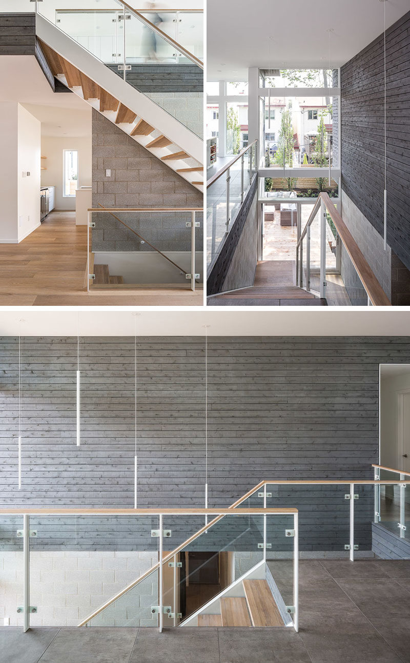 Stair Ideas - This modern open-riser stair rises up through a large double-height space, while honed concrete-block walls and grey-stained cedar siding are showcased on the walls. #StairIdeas #Stairs #Staircase #ModernStairs #CedarSiding #WoodAccentWall