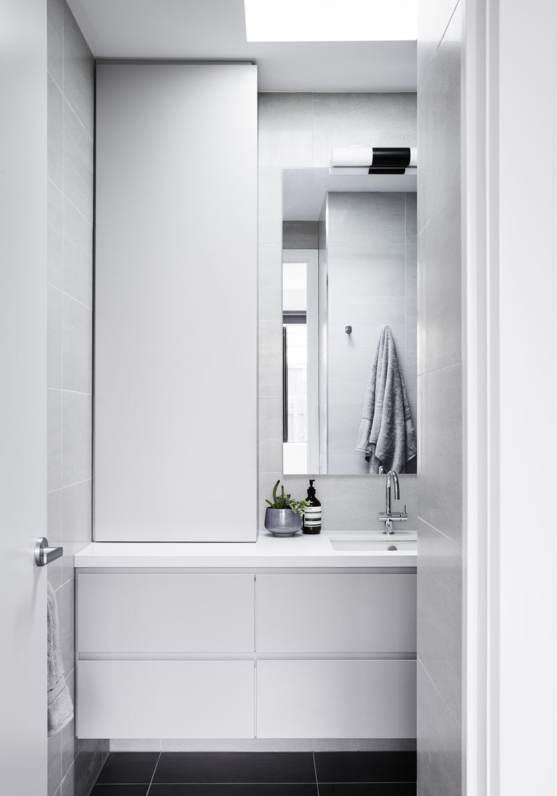 In this small bathroom, the design has been kept minimal, while a skylight draws the eye upwards to the natural light, making the room feel larger and brighter. #Skylight #SmallBathroom #BathroomDesign