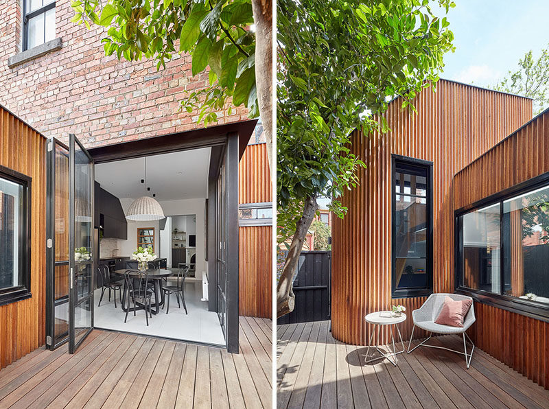 Folding glass doors open the dining area and kitchen of this updated house, to a new timber courtyard, while new wood extension adds extra living area to the home. #Courtyard #WoodAddition