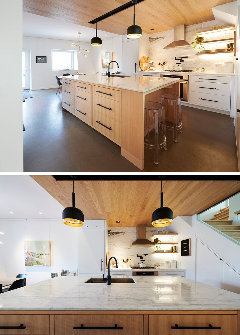 Kitchen Design Ideas - This modern kitchen is defined by the use of a wood ceiling. A large kitchen island provides more counter space, additional storage, and a place for a couple of stools. #KitchenDesignIdeas #WoodCeiling #ModernKitchen #KitchenIsland