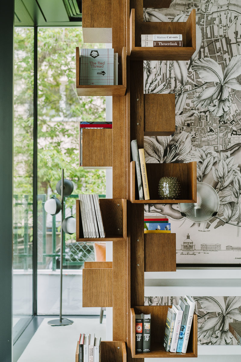 Bookshelf Ideas - This vertical wood bookshelf has small shelves that are mounted on a central column, allowing all four sides to have book storage. #BookshelfIdeas #WoodBookshelf #ColumnBookshelf