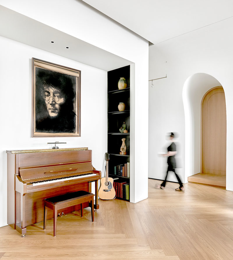 This modern penthouse has small alcoves, like this one, that has been designated as a music area with a piano and guitar stand. #MusicNook #Alcove #InteriorDesign