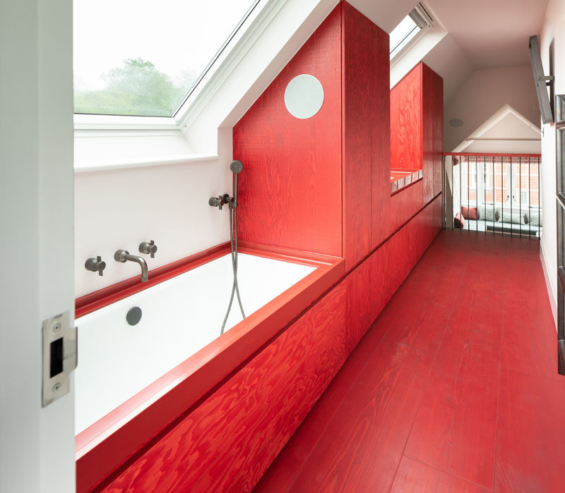 Bathroom Ideas - This modern and bright red bathroom has an integrated Red Corian bathtub surround and sink, that complete the bold color block aesthetic. #RedBathroom #BathroomIdeas #ModernBathroom