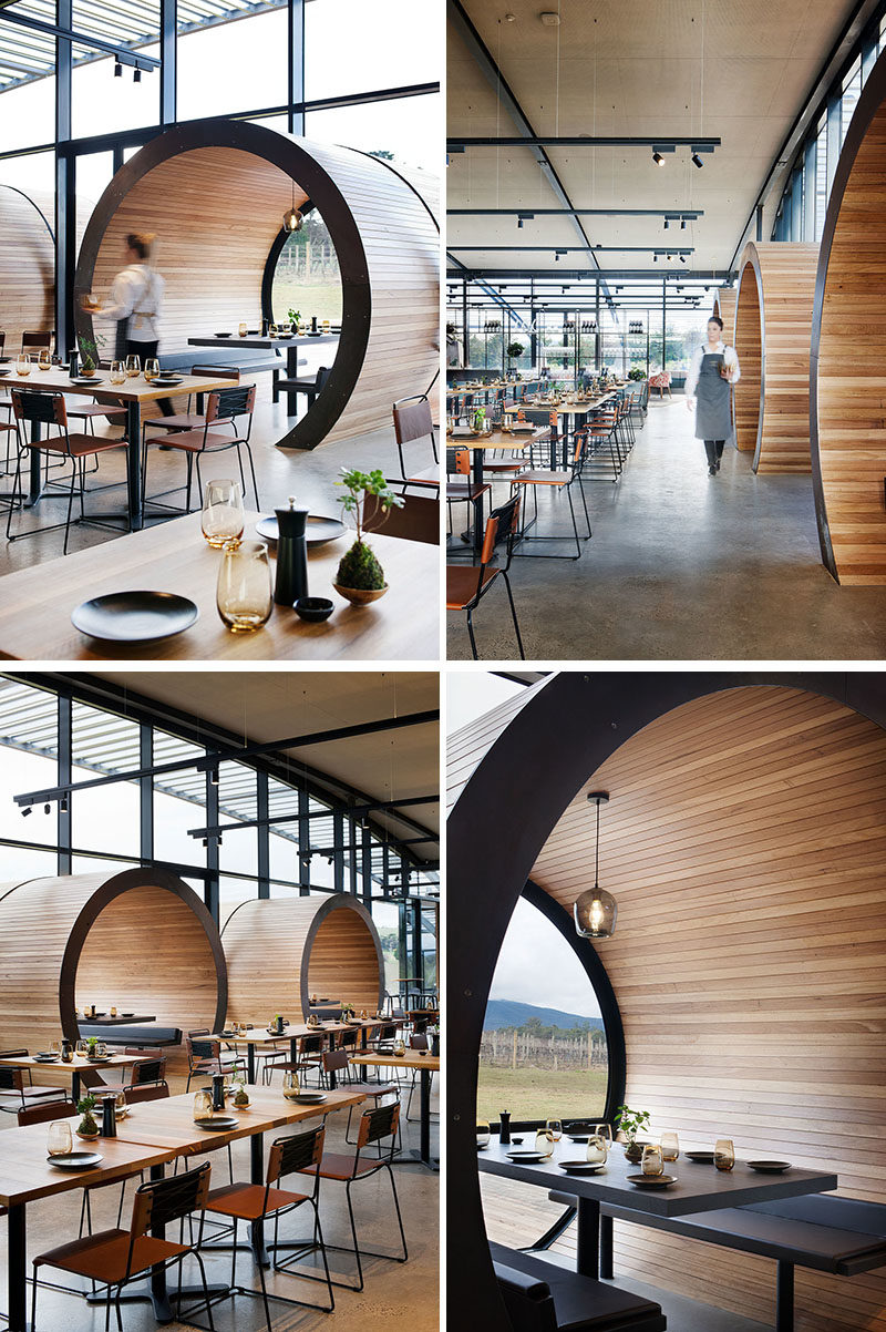 Restaurant Design Ideas - Timber lined barrel booths are positioned along one of the walls of windows in this restaurant, creating a semi-private dining experience, and referencing the wine barrels used within the winery. #RestaurantIdeas #RestaurantDesign #Winery #Seating #Booths