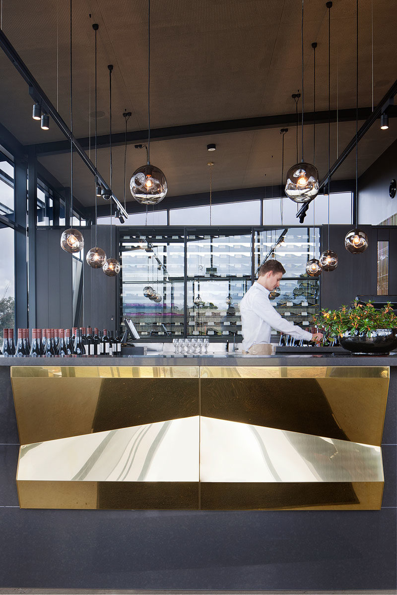 Bar Ideas - These modern winery tasting bars feature a repetitive tectonic form of shifting brass panels to reflect the undulating landscape. #BarIdeas #HospitalityDesign #RestaurantDesign