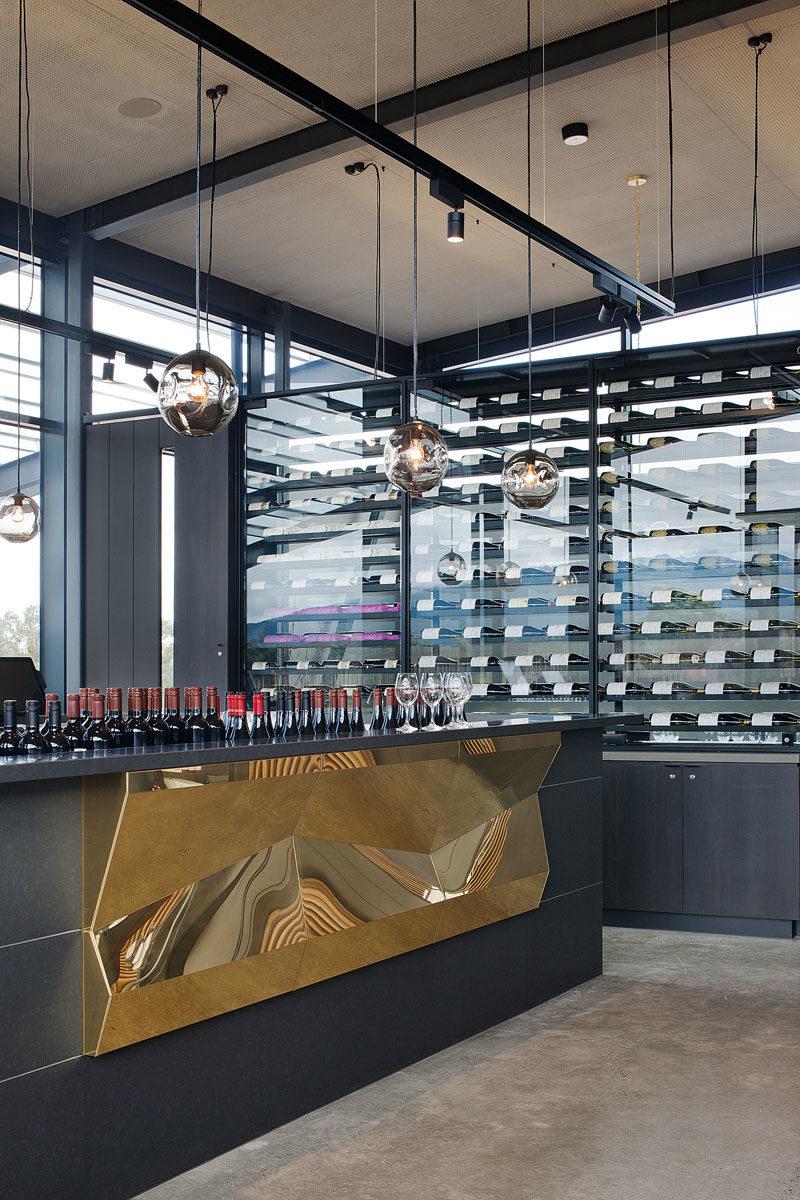 Bar Ideas - These modern winery tasting bars feature a repetitive tectonic form of shifting brass panels to reflect the undulating landscape. #BarIdeas #HospitalityDesign #RestaurantDesign