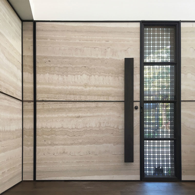 Front Door Ideas - This modern front door has a brass woven ribbon mesh exterior, and a travertine slab interior. #ModernFrontDoor #DoorIdeas #FrontDoor