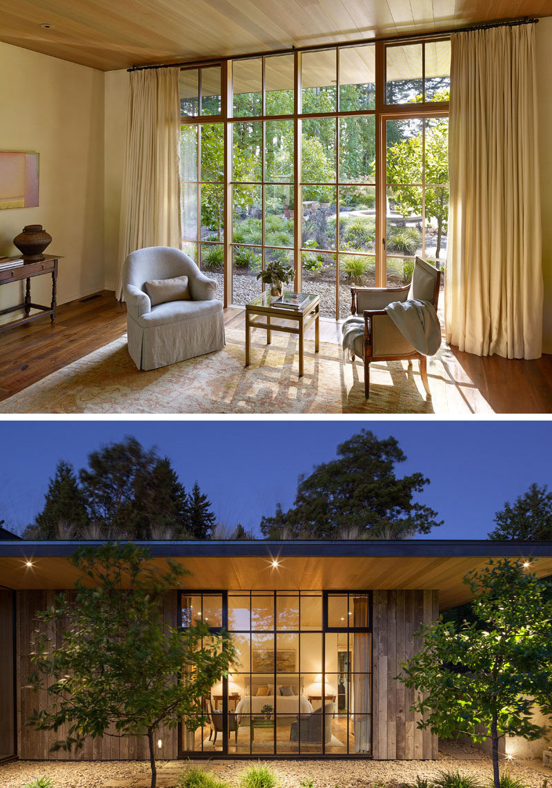 Window Ideas - In this bedroom, there's a wall of grid window frames that allow natural light to fill the room, while the wood ceiling transitions from interior to exterior. #Windows #Bedroom #WindowIdeas