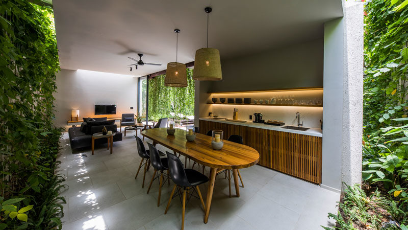 This modern villa has a kitchen with hidden lighting, and green walls that add a touch of nature. #Kitchen #DiningRoom #GreenWalls