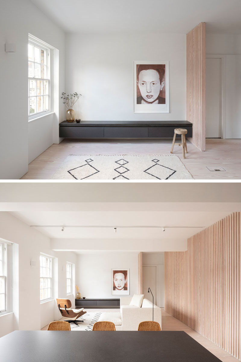 Interior Design Ideas - The wood slat wall in this modern apartment incorporates secret doors, and all storage and service requirements for the apartment, including kitchen appliances and hanging cupboards, resulting in a highly efficient plan. #InteriorDesignIdeas #WoodSlatWall #HiddenAppliances #HiddenFridge #IntegratedFridge #HiddenStorage #SecretDoors #HiddenDoors