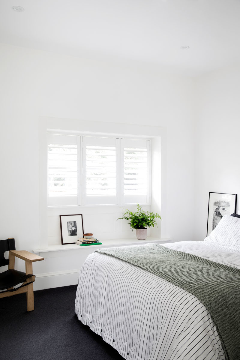 Bedroom Ideas - In this contemporary bedroom, dark carpet creates a soft touch underfoot, and contrasts the bright white walls. #BedroomIdeas #DarkCarpet #ContemporaryBedroom