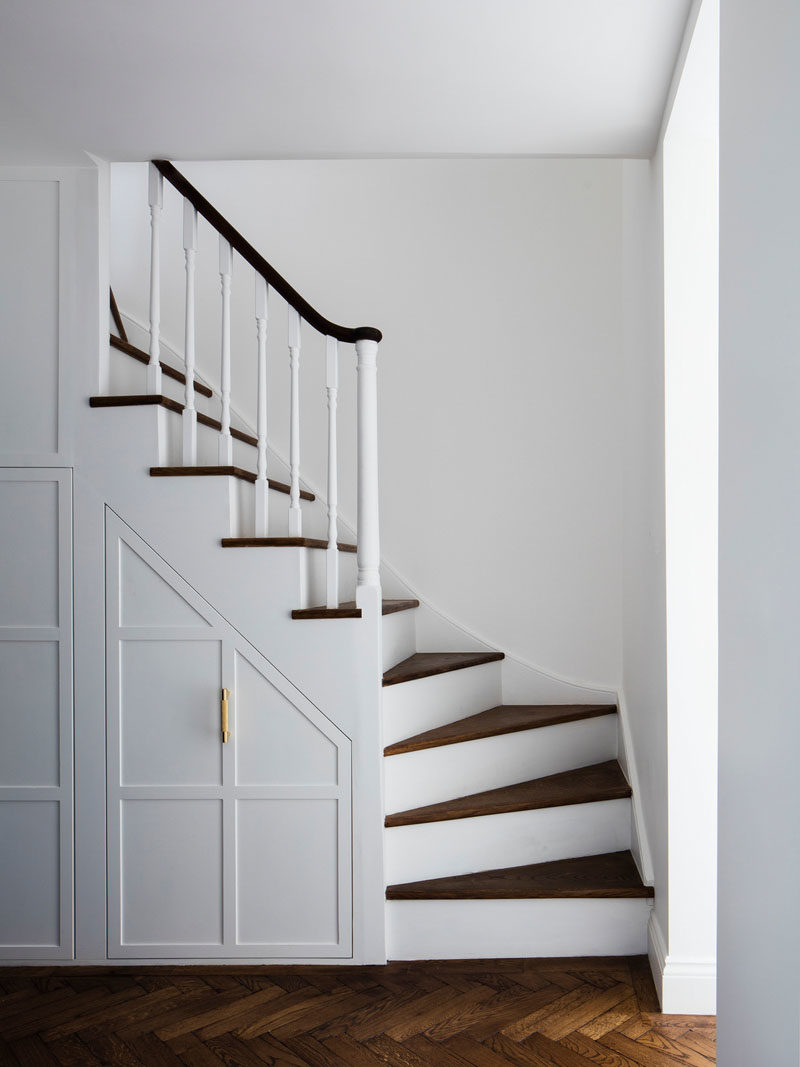 Stair Ideas - The original carpeted stairs were refinished, and the stair treads transformed with wood. Under the stairs, the pull-out cupboards have been extended, providing more storage. #Stairs #StairsWithStorage #StairDesign #StairIdeas