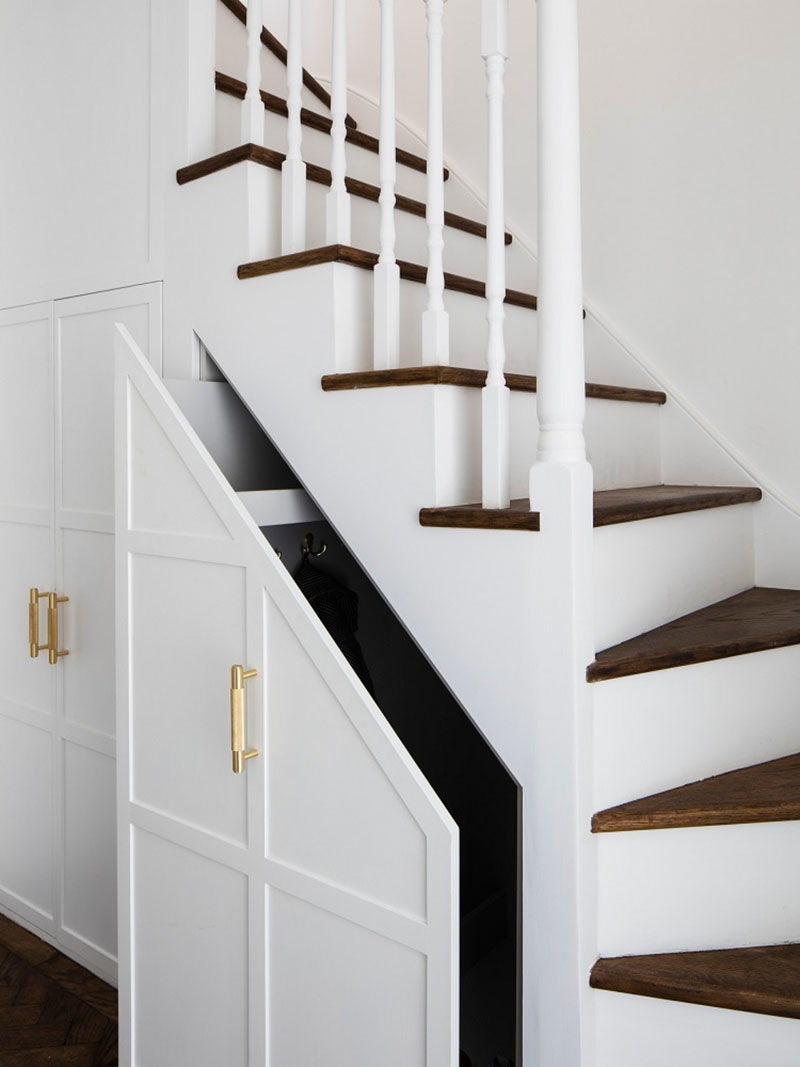 Stair Ideas - The original carpeted stairs were refinished, and the stair treads transformed with wood. Under the stairs, the pull-out cupboards have been extended, providing more storage. #Stairs #StairsWithStorage #StairDesign #StairIdeas