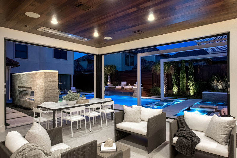 This modern pool cabana features a covered sitting and dining area. #PoolCabana