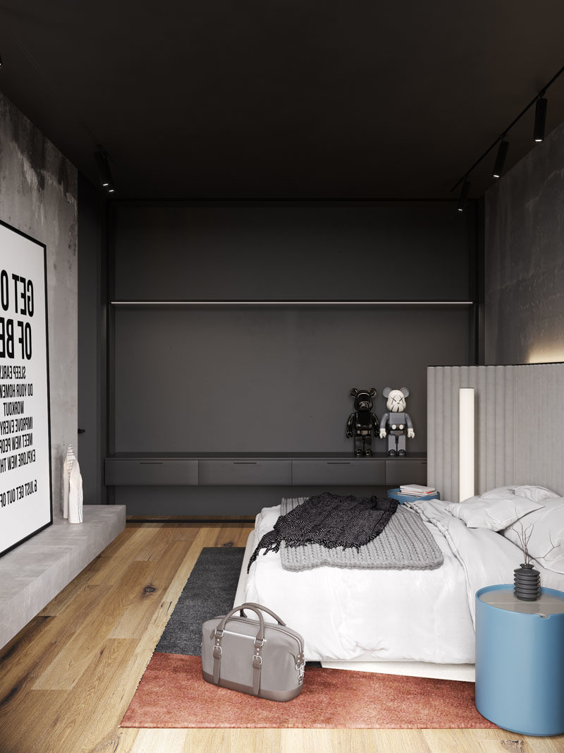 Bedroom Ideas - In this modern bedroom, the concrete walls were left bare, while hidden lighting behind the headboard adds a soft glow to the room. #BedroomIdeas #ModernBedroom #BacklitHeadboard