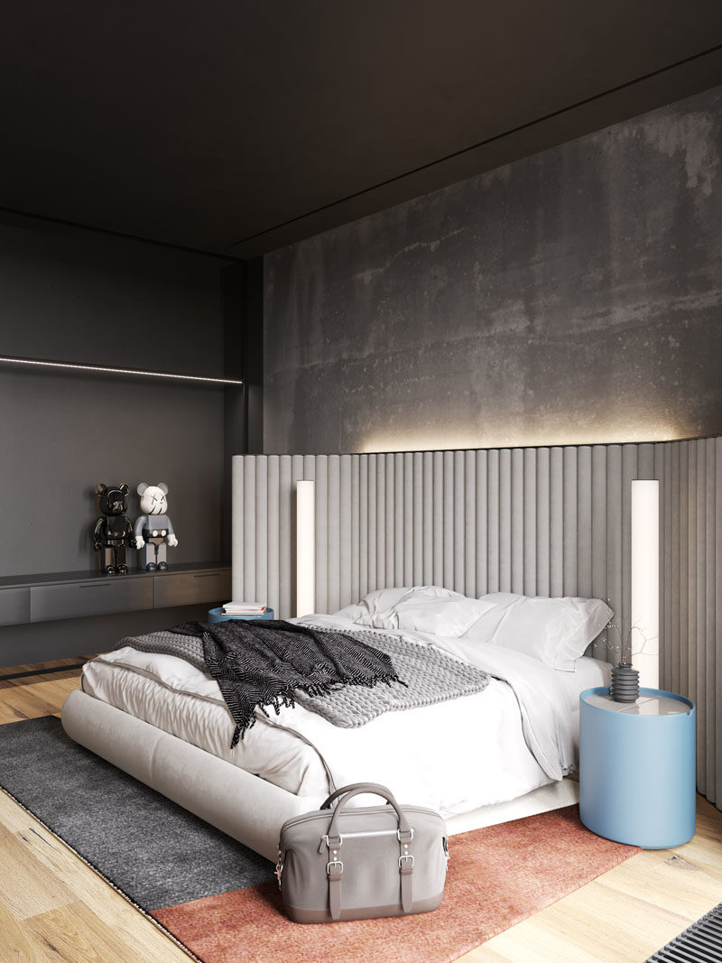 Bedroom Ideas - In this modern bedroom, the concrete walls were left bare, while hidden lighting behind the headboard adds a soft glow to the room. #BedroomIdeas #ModernBedroom #BacklitHeadboard