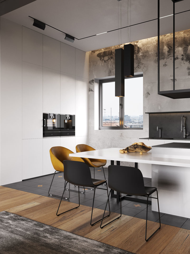 Kitchen Ideas - This modern mostly white kitchen, has stainless steel peninsula that's surrounded by a counter, that acts as a dining area. #KitchenIdeas #KitchenDesign #ModernKitchen #WhiteKitchen