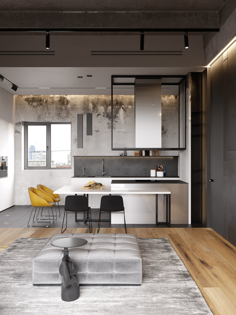 Kitchen Ideas - This modern mostly white kitchen, has stainless steel peninsula that's surrounded by a counter, that acts as a dining area. #KitchenIdeas #KitchenDesign #ModernKitchen #WhiteKitchen