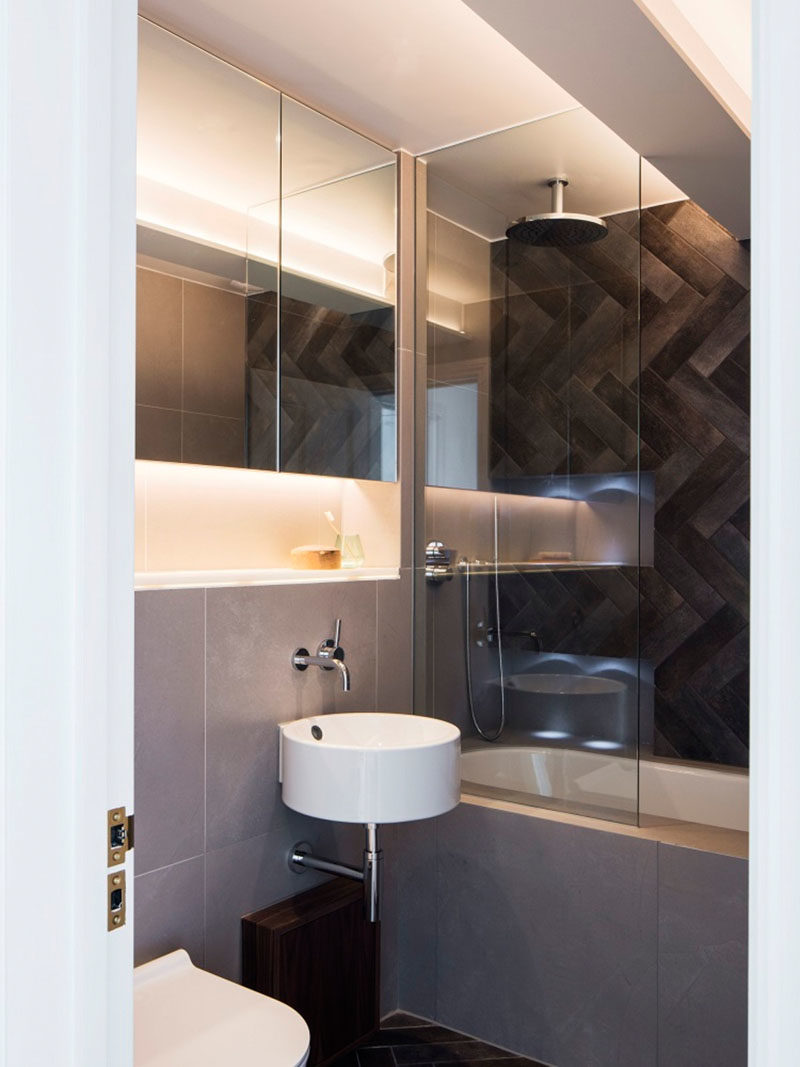 Bathroom Ideas - In this main bathroom, a rainwater shower head has been installed above the bath, while a glass shower screen provides a barrier from the rest of the bathroom. #BathroomIdeas #ModernBathroom