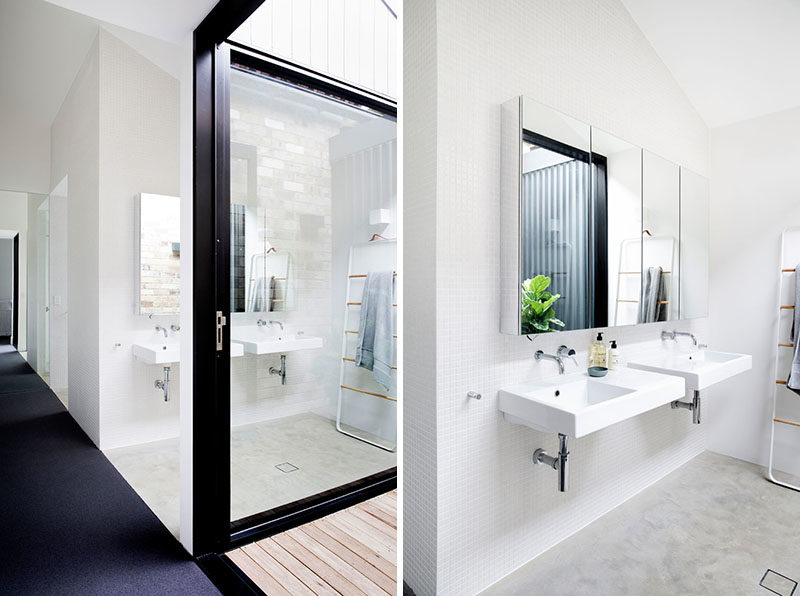 Bathroom Ideas - In this bathroom, dual sinks have been mounted below a mirror that reflects a small internal courtyard. #BathroomIdeas #ModernBathroom