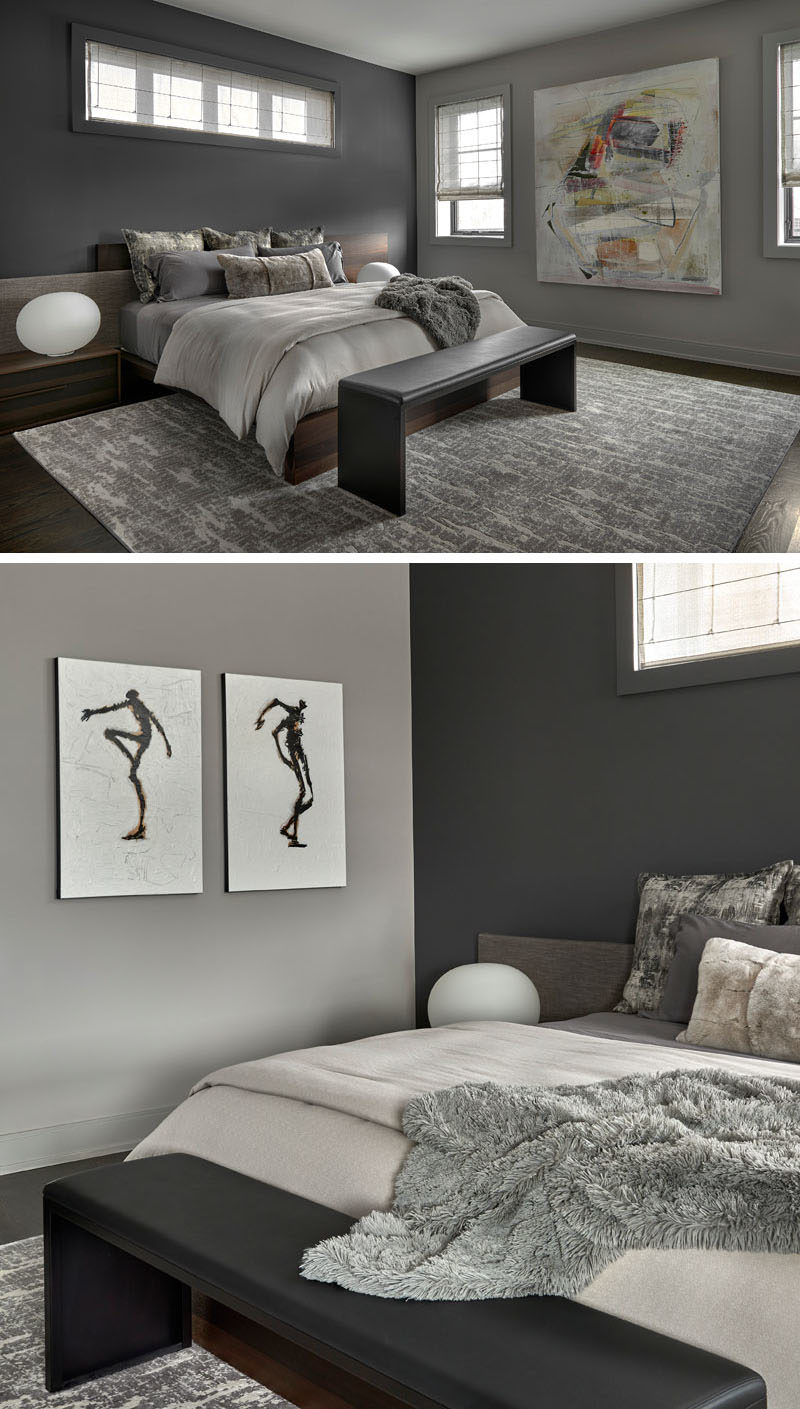 Bedroom Ideas - This modern master bedroom features a wood bed frame with an asymmetrical upholstered and walnut headboard, that also has integrated nightstands. A large wool area rug adds warmth to the room, while Roman shades (with hidden blackout roller shades) add a soft touch. #BedroomIdeas #ModernBedroom #BedroomDesign