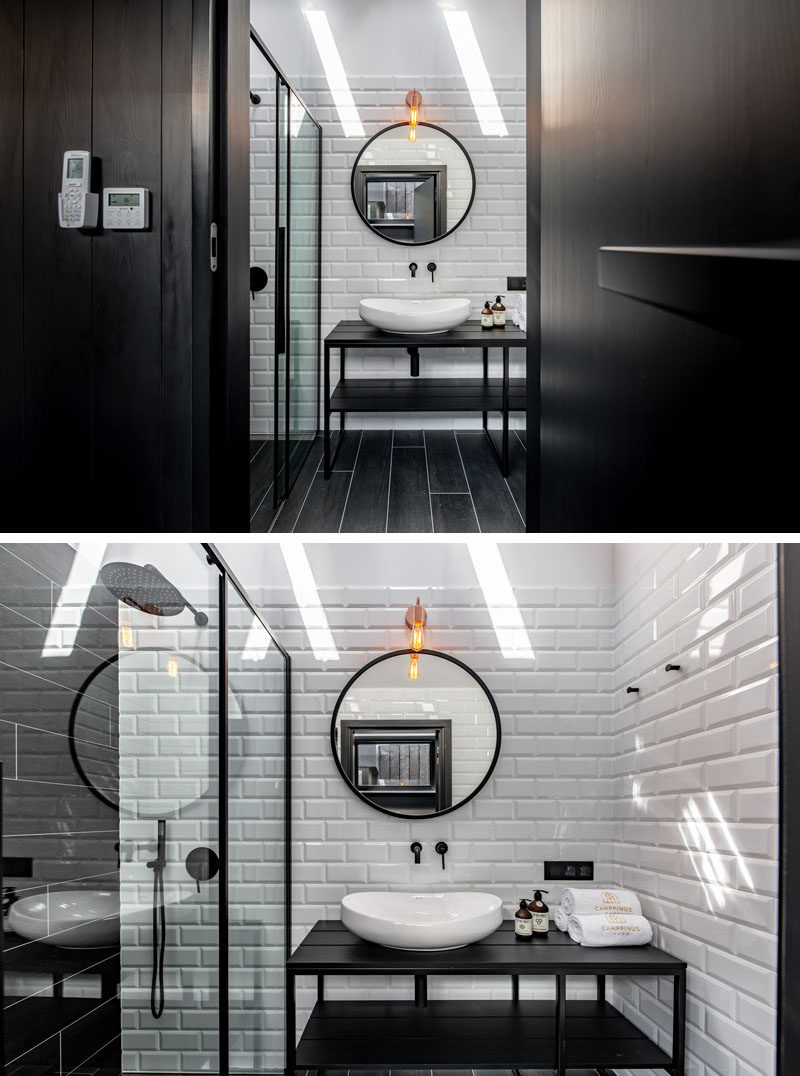 Bathroom Ideas - Black design elements are featured in this modern bathroom, with a black vanity, black flooring, and black shower frame. White tiles and skylights help to keep the room bright. #BlackBathroom #BathroomIdeas #Bathroom #ModernBathroom
