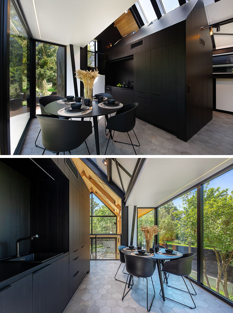 Dining Room Ideas - This small open-plan dining area, that's furnished with black table and chairs, complements the adjacent black kitchen. #DiningRoomIdeas #BlackKitchen