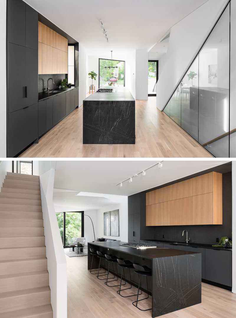 Kitchen Ideas - Inside this modern house, the matte black kitchen cabinets and island draw the attention in the mostly white interior. #BlackKitchen #KitchenIdeas #ModernKitchen #BlackKitchenIsland