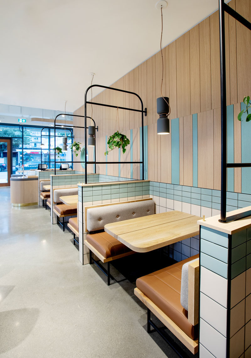 Restaurant Ideas - Black, tubular metalwork was used throughout the space as layering and framing elements to define seating areas whilst allowing the bright, open atmosphere to remain. #RestaurantIdeas #RestaurantDesign #RestaurantSeating #Booths