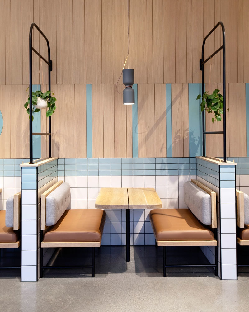 Restaurant Ideas - Black, tubular metalwork was used throughout the space as layering and framing elements to define seating areas whilst allowing the bright, open atmosphere to remain.  #RestaurantIdeas #RestaurantDesign #RestaurantSeating #Booths