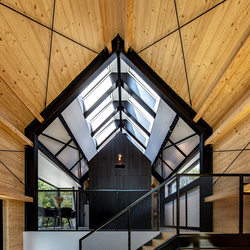 This holiday resort house features high ceilings with skylights, and visible structural elements. #Architecture #Windows