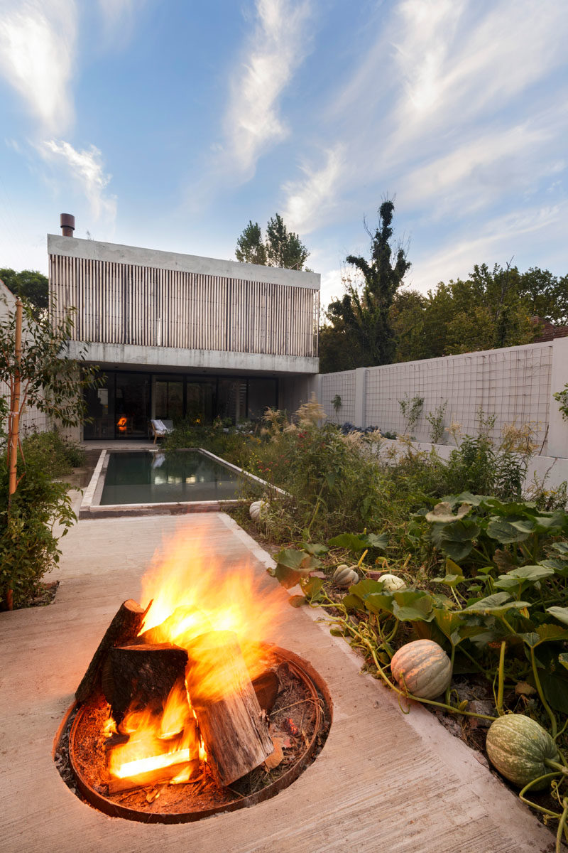 Landscaping Ideas - This modern house has a swimming pool, a vegetable garden, and a patio with a fire pit. #ModernYard #SwimmingPool #Landscaping #LandscapeDesign