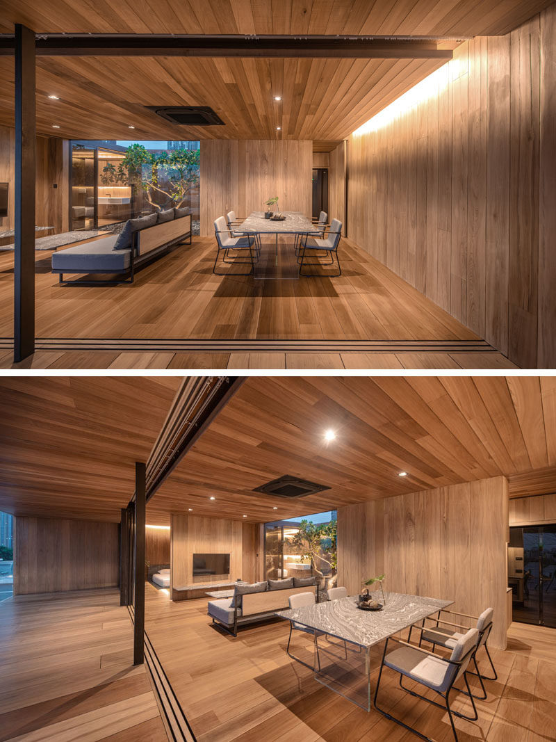 Living Room Ideas - This modern wood house, which also features plenty of glass walls, has an open living room and dining room. #LivingRoom #ModernWood #WoodInterior #HiddenLighting