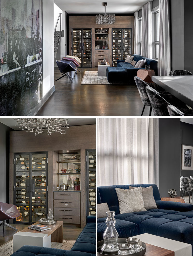 Wine Room Ideas - This modern wine room has been furnished with a ink blue sectional, has custom-built wine chillers, and a chandelier by Lucy Slivinsky, that's made of metal car parts. #WineRoom #WineStorage #Lounge #HomeBar