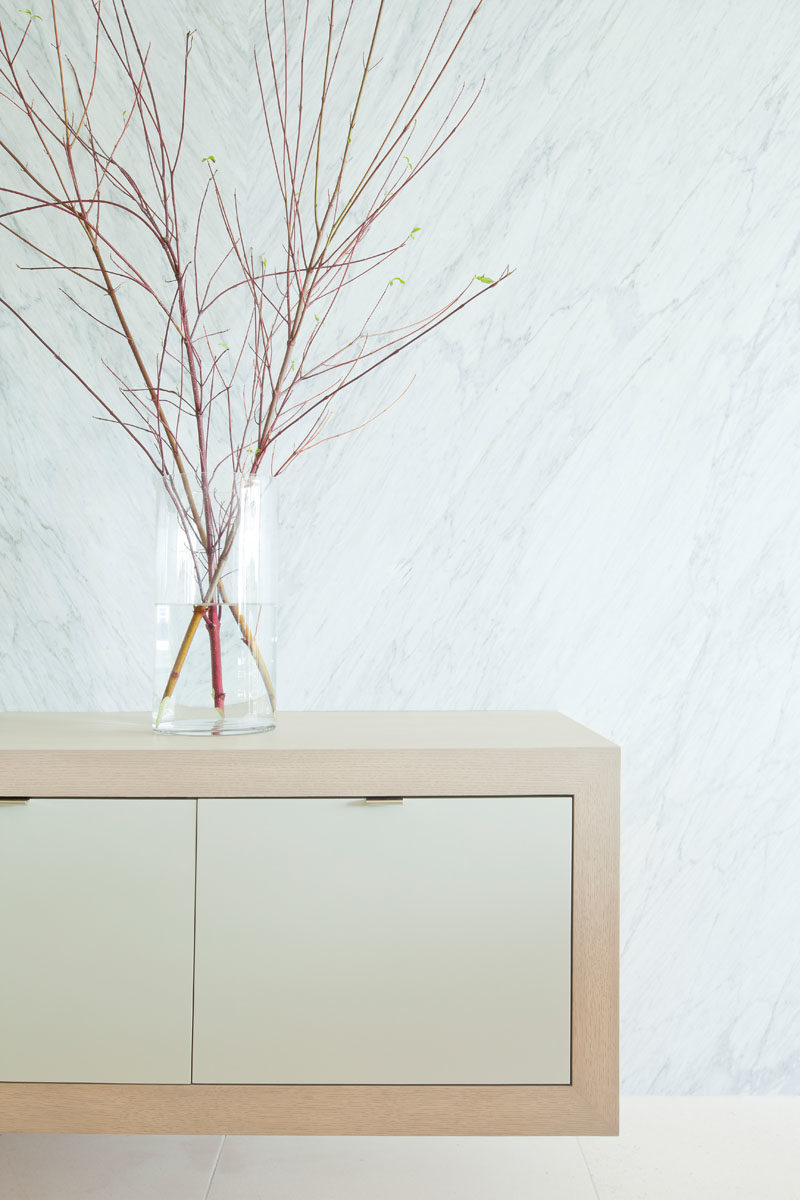 Decor Ideas - A simple floating wood cabinet is topped with a glass vase that showcases a collection of twigs. #ModernDecor #DecorIdeas