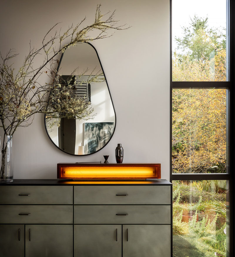 Decor Ideas - In this dining room, a Wintercheck Factory Light sits atop a credenza by Wüd Furniture. #HomeDecor #FurnitureIdeas