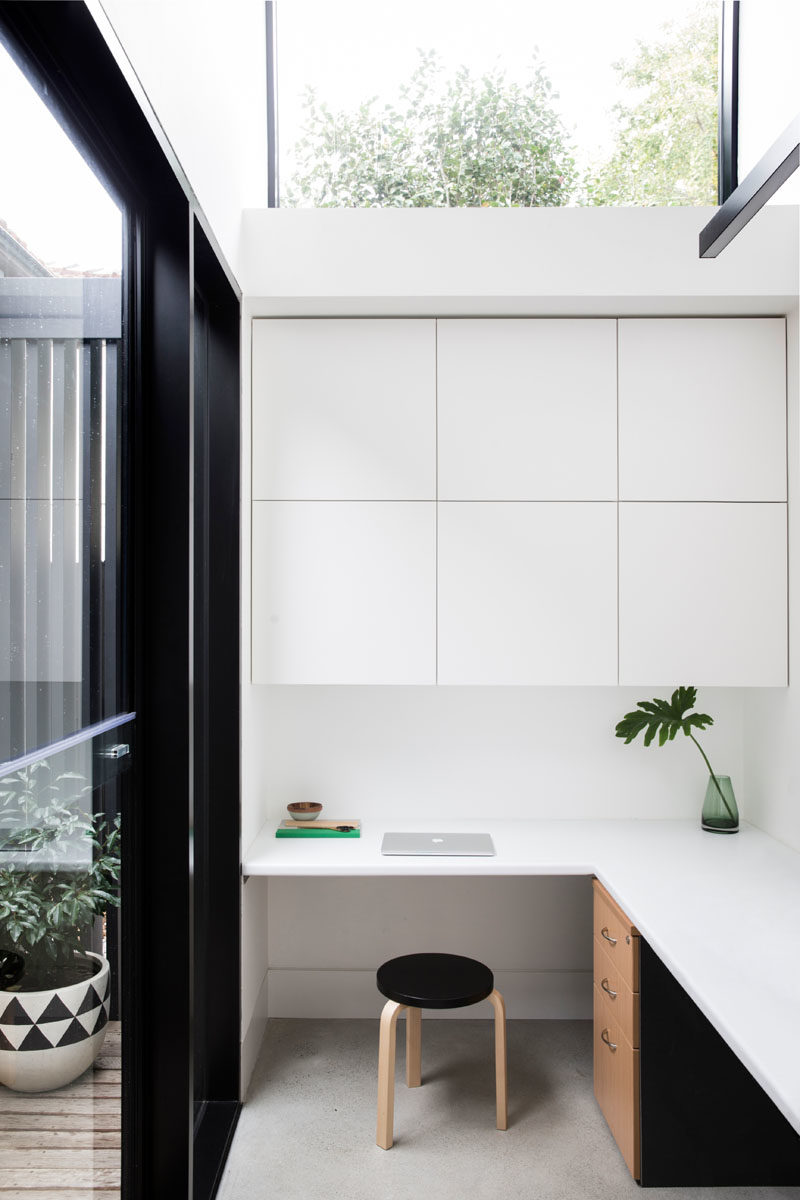 Home Office Ideas - This small home office features a built-in desk and minimalist cabinets. #HomeOffice #InteriorDesign