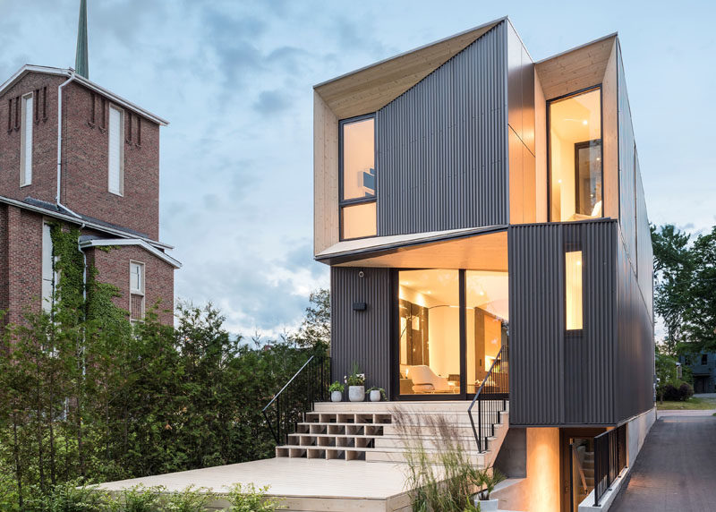 The angled portions of this modern house are highlighted by the use of wood, which directly contrasts the black window frames and the dark steel corrugated siding. #ModernArchitecture #HouseDesign #Windows #ModernHouse