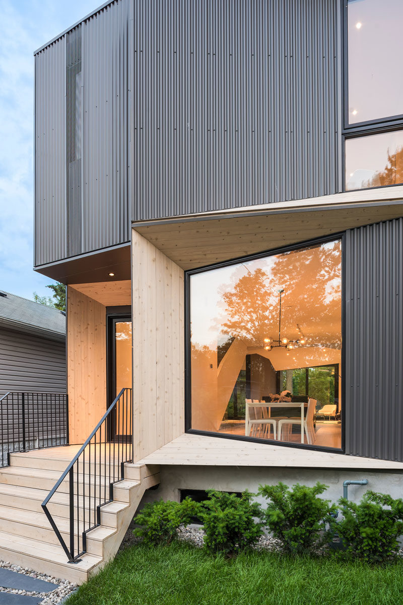 The angled portions of this modern house are highlighted by the use of wood, which directly contrasts the black window frames and the dark steel corrugated siding. #ModernArchitecture #HouseDesign #Windows #ModernHouse