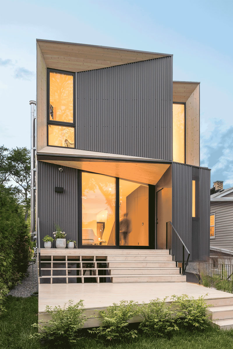 The angled portions of this modern house are highlighted by the use of wood, which directly contrasts the black window frames and the dark steel corrugated siding. #ModernArchitecture #HouseDesign #Windows #ModernHouse