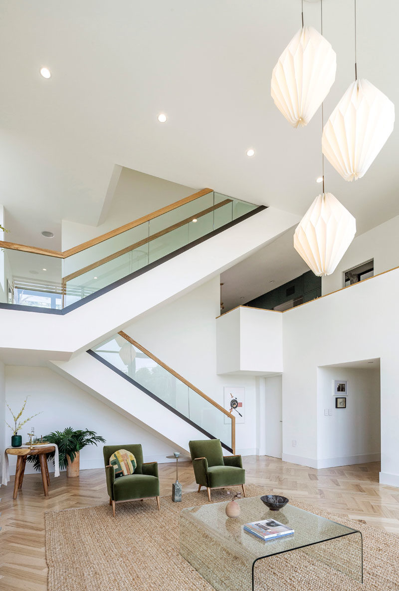 Stair Ideas - This modern house has a large staircase with glass and wood handrails. #Stairs #StairIdeas #ModernStairs