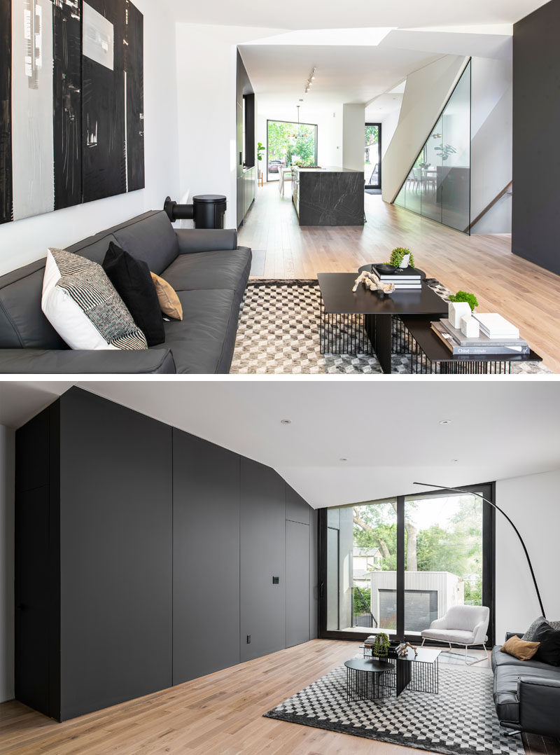 Living Room Ideas - A minimalist black accent wall matches the kitchen and hides a powder room and mudroom. #ModernLivingRoom #LivingRoomIdeas #BlackAccentWall #BlackFeatureWall