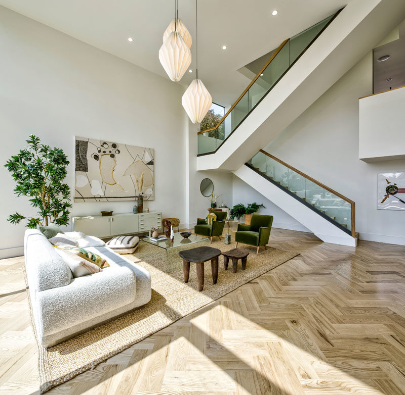 Stair Ideas - This modern house has a large staircase with glass and wood handrails. #Stairs #StairIdeas #ModernStairs #LivingRoomIdeas
