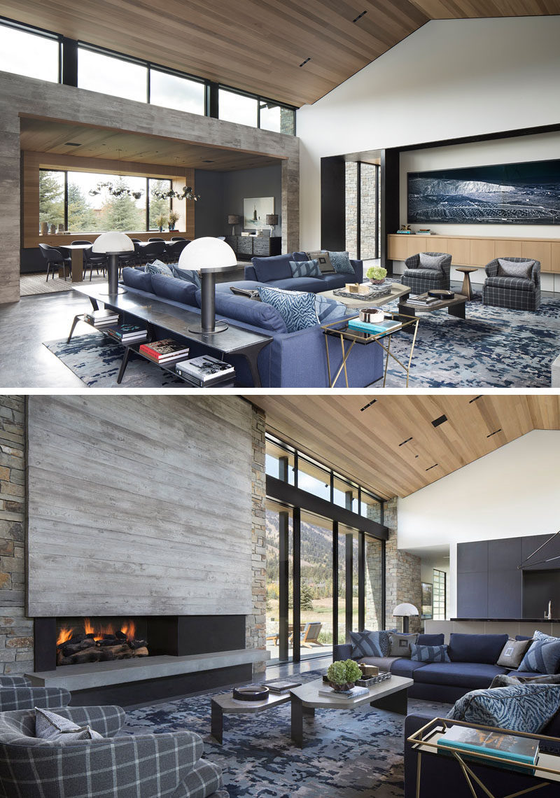 Living Room Ideas - In this modern great room, there's high ceilings covered in wood, and a large living room that's focused on the fireplace. #LivingRoomIdeas #GreatRoomIdeas #ModernLivingROom #Windows #WoodCeiling
