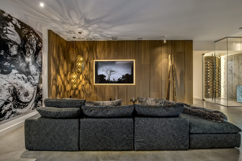 Living Room Ideas - In this modern living space, walls of white Rift Oak paneling have been used too add a touch of warmth to the space. #LivingRoomIdeas #ModernLivingRoom #WoodAccentWall #LivingRoom